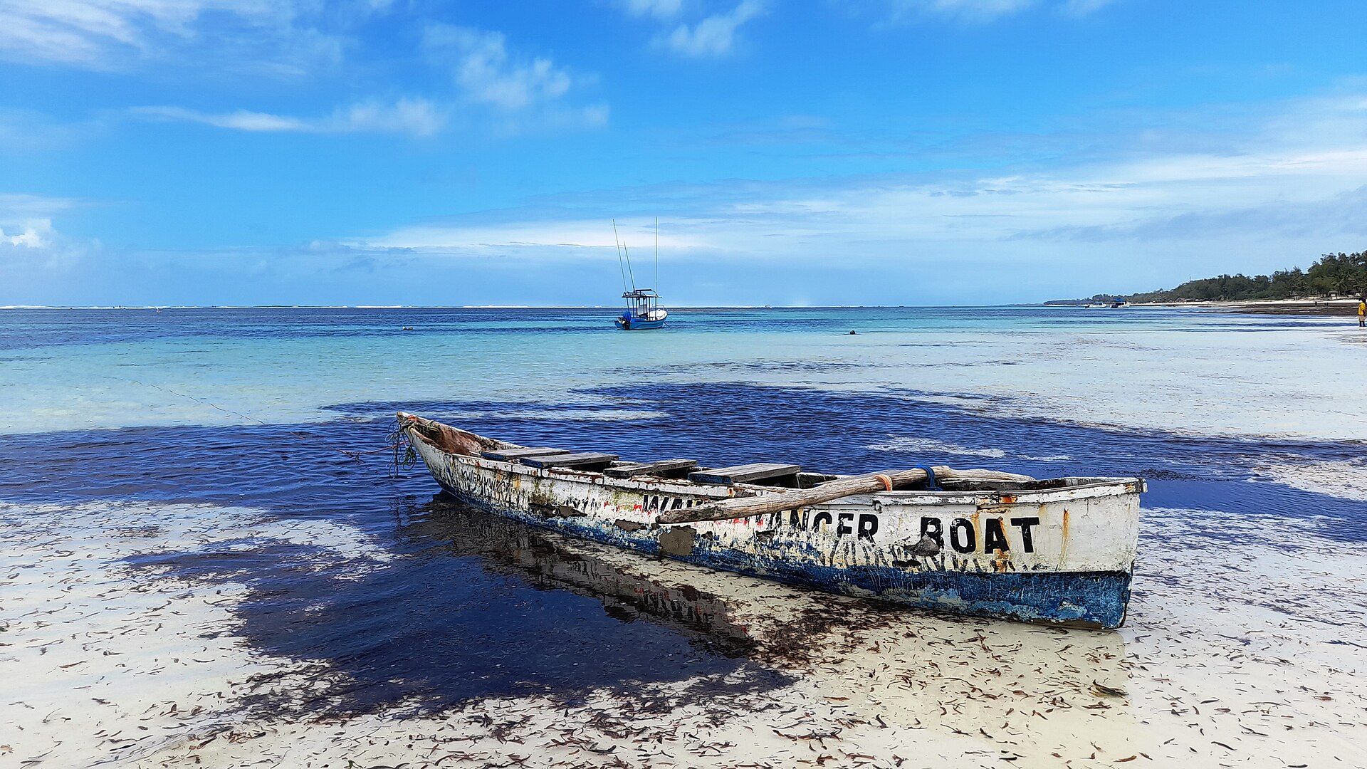 Traditional boat on the white coral sand of Diani Beach