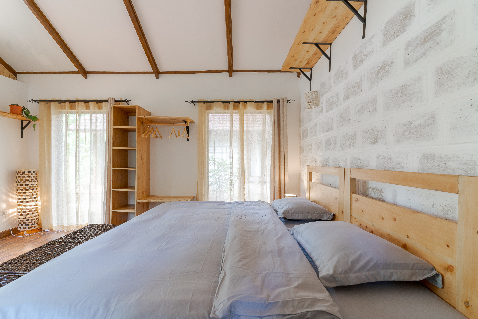 Jungle Oasis — vaulted bedroom with open wardrobe and natural light