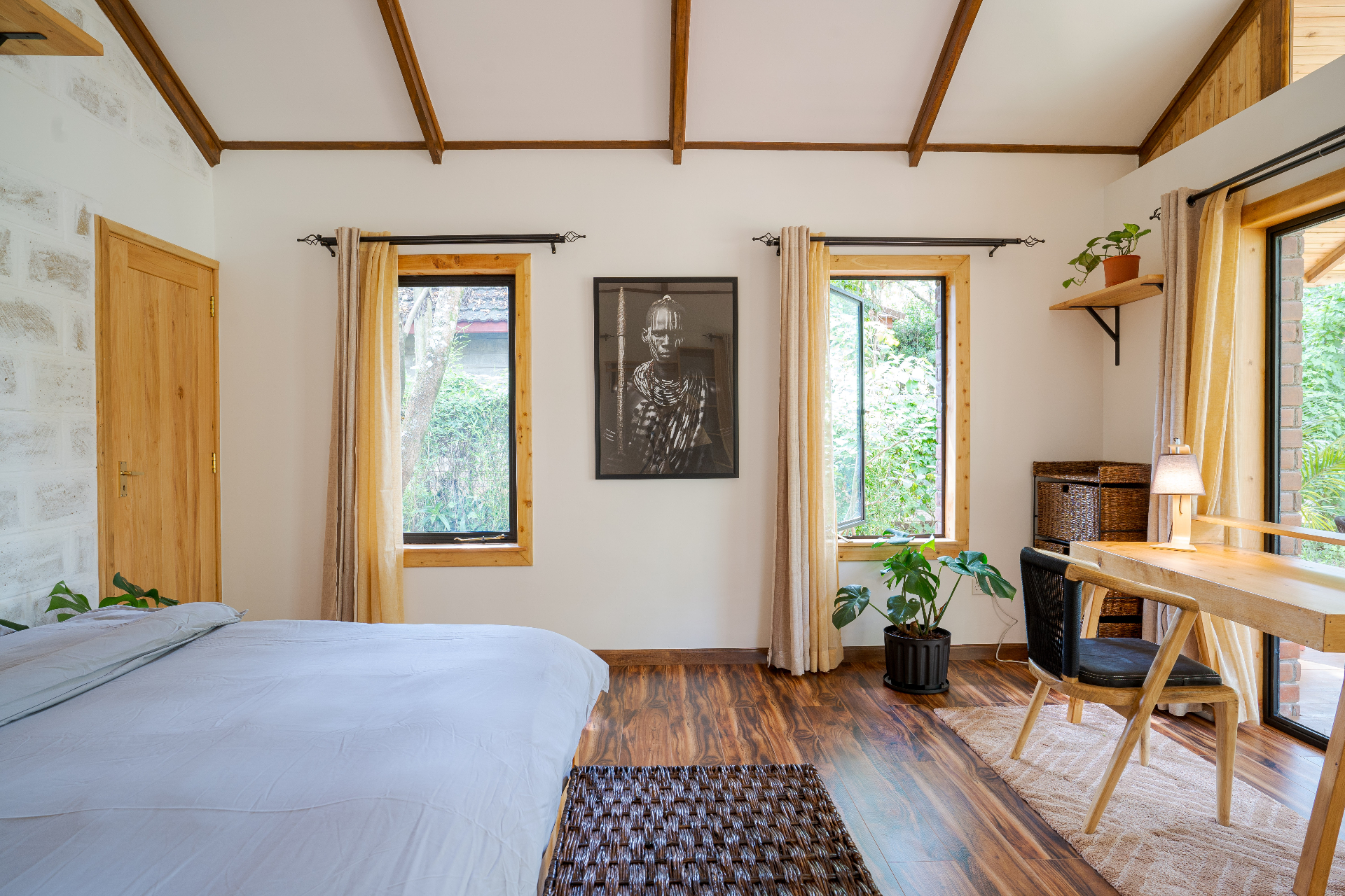 Jungle Oasis — airy bedroom with work area and forest-facing windows