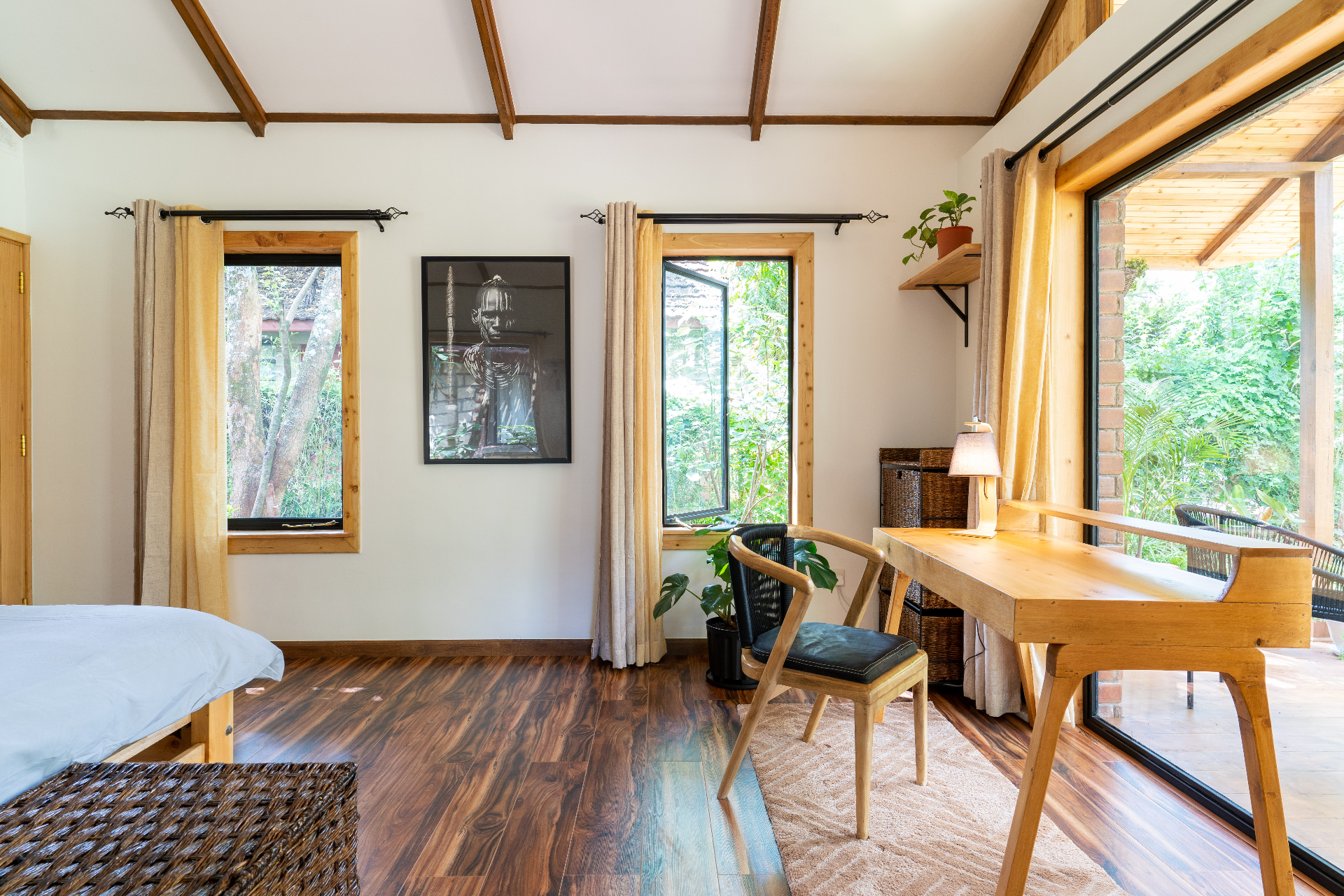 Jungle Oasis — bright living area with desk and garden views